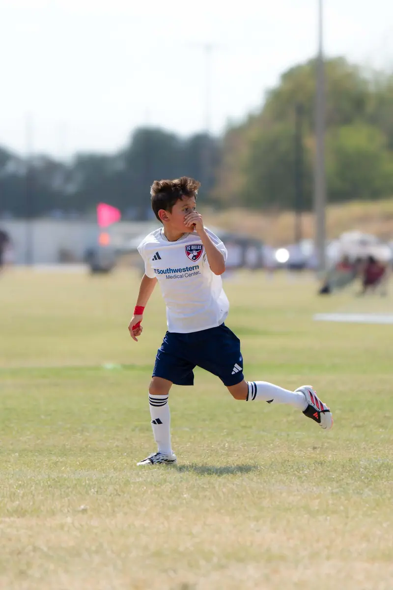 Youth soccer player celebrating after a goal on the run