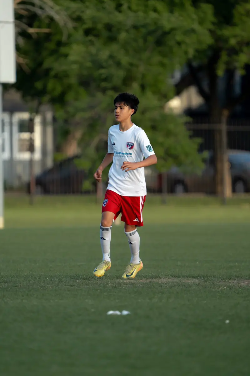 Teen FC Dallas player in golden hour light
