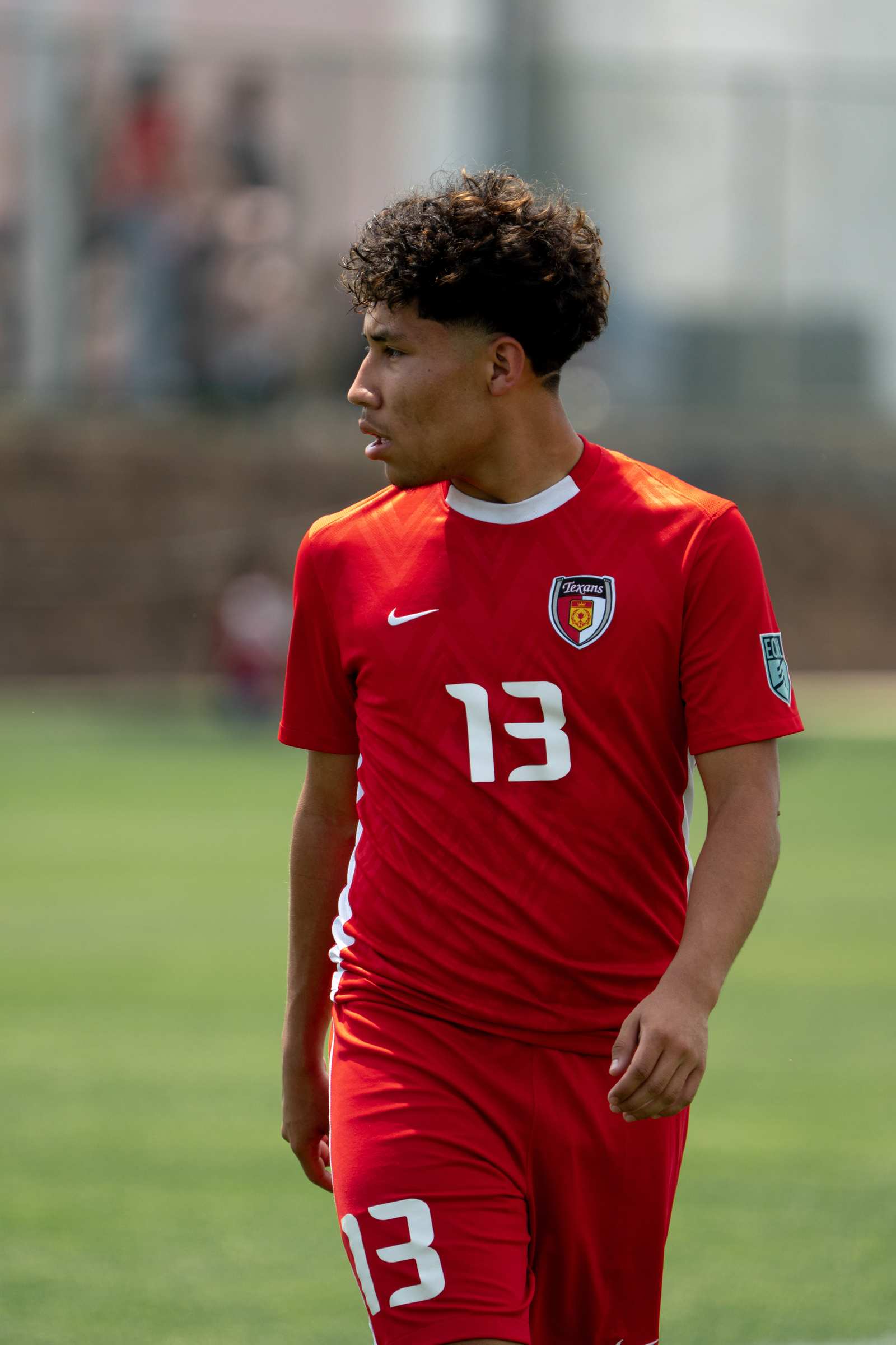 Close portrait of a youth soccer player locked in before kickoff