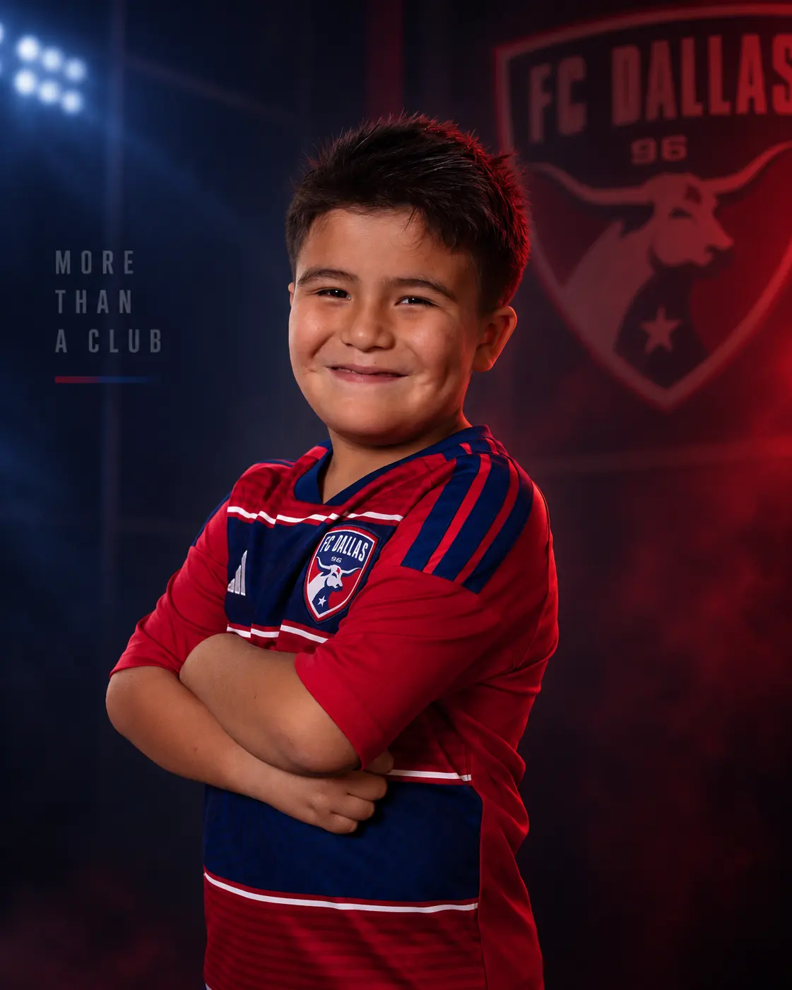 Youth FC Dallas player media day portrait, arms crossed, on a club crest background